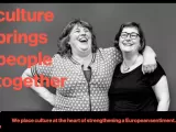 Two women in a half hug laughing, with the text 'culture brings people together'.