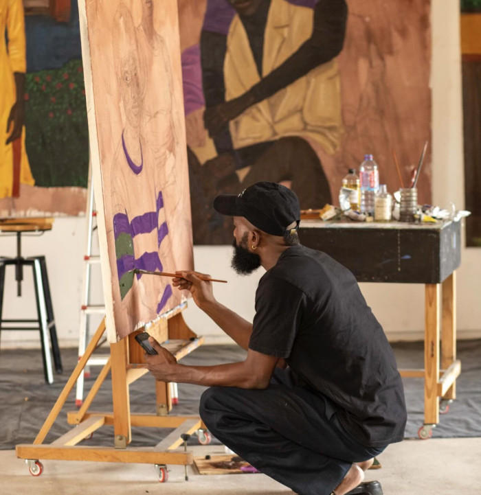 A person at an easel painting. 