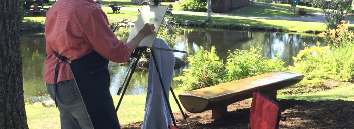 A person painting outside. 