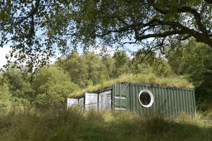 A small building in a forest environment. 