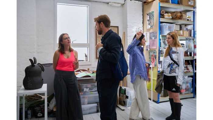 People standing in a creative office space. 