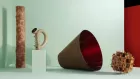 Four objects in a gallery setting. 