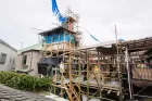 A house in construction with bamboo scaffolding. 