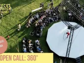 Text from the call with a photo of an outdoor circus performance with an audience, seen from above. 