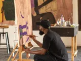 A person at an easel painting. 
