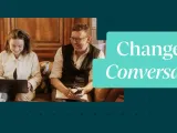 Three people on a sofa, with a laptop, talking. 