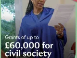 Text of the call on a photo of a person reading from a sheet of paper. 