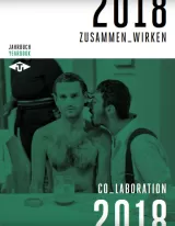 Cover for ITI's 2018 Yearbook. Shows a photograph of a man, naked from the waist up, sitting at a restaurant table. Another man, mouth very close to the first man's left ear, appears to be singing into it.